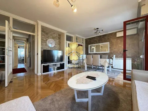 Spacious and furnished living room with a dining area and parquet flooring. - image 2
