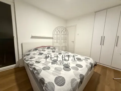 Bedroom with a double bed, white wardrobe, and wooden flooring. - image 6