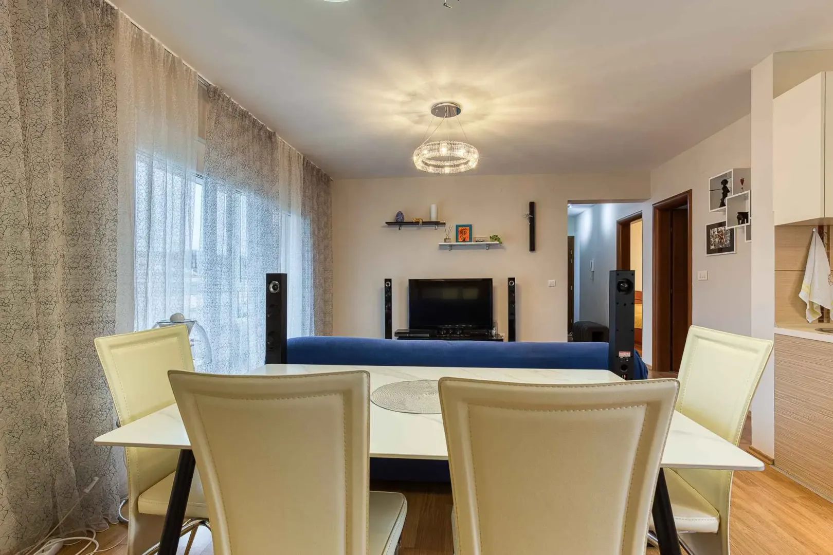 Living room with a dining table and chairs in the foreground.