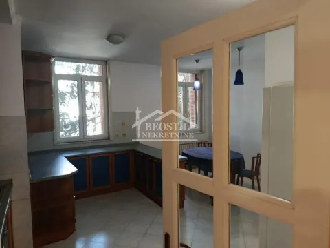 View from the kitchen towards the dining area through a glass-paneled door. - image 10