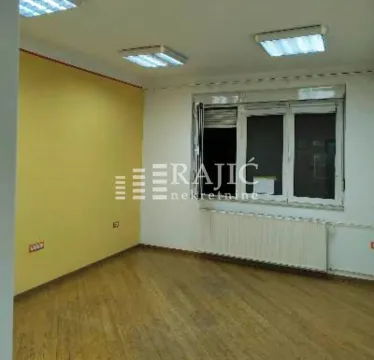 Empty room with hardwood floors, a yellow wall, and a window. - image 3