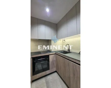 Modern kitchen with wooden cabinets, dark countertop, and built-in appliances. - image 6