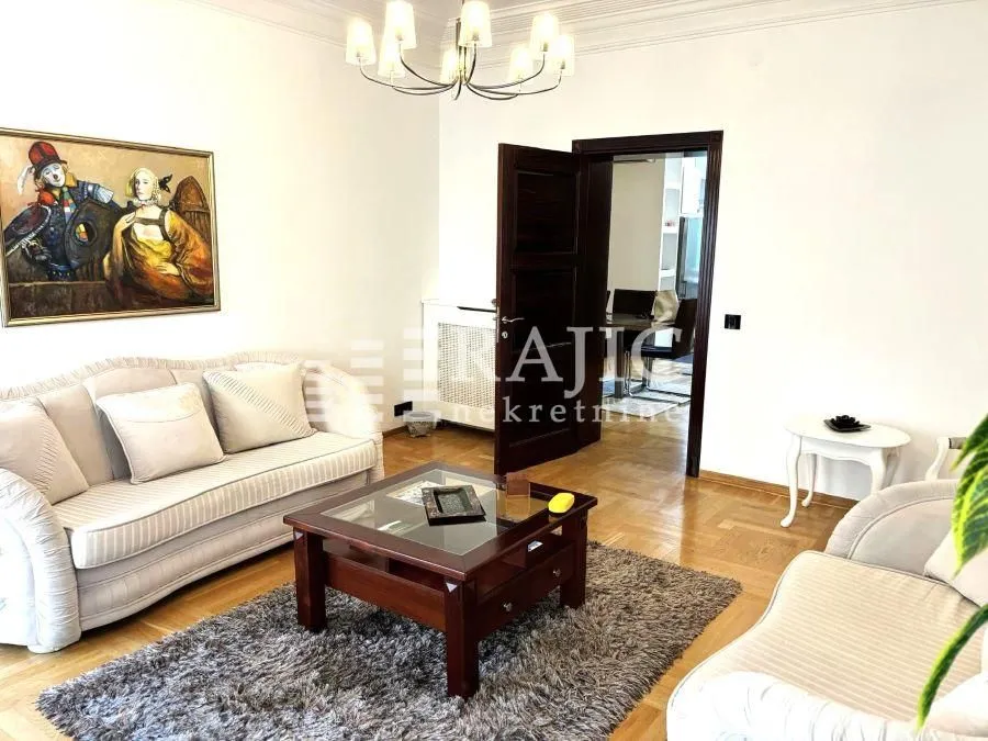 Spacious living room with sofa set and an art painting on the wall.