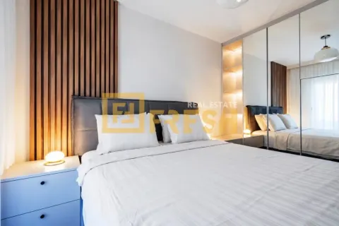 Modern bedroom with a double bed, wooden wall panel, and a large mirrored wardrobe. - image 10