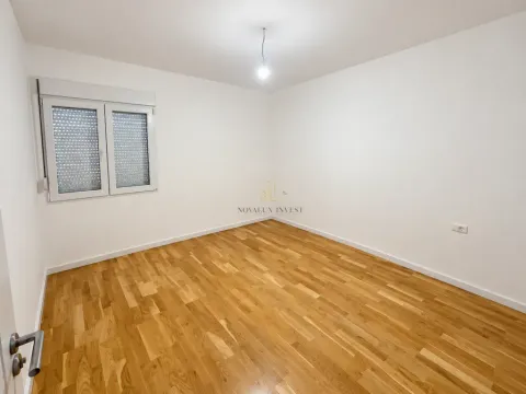 Empty room with white walls and wooden flooring. - image 7