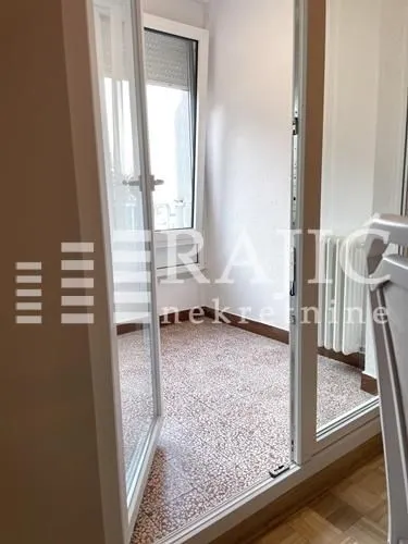 View through open balcony doors onto an enclosed terrace.