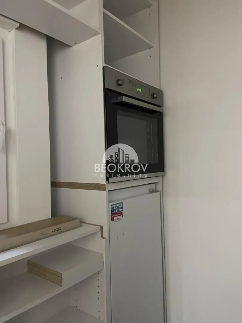 White kitchen units with a built-in oven.