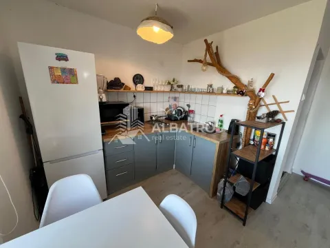 Small kitchen with a dining table and refrigerator. - image 5