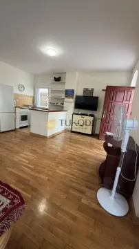 Living room with kitchen and wooden floor. - image 5