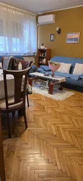 Living room with a sofa set, dining table and parquet flooring. - image 16
