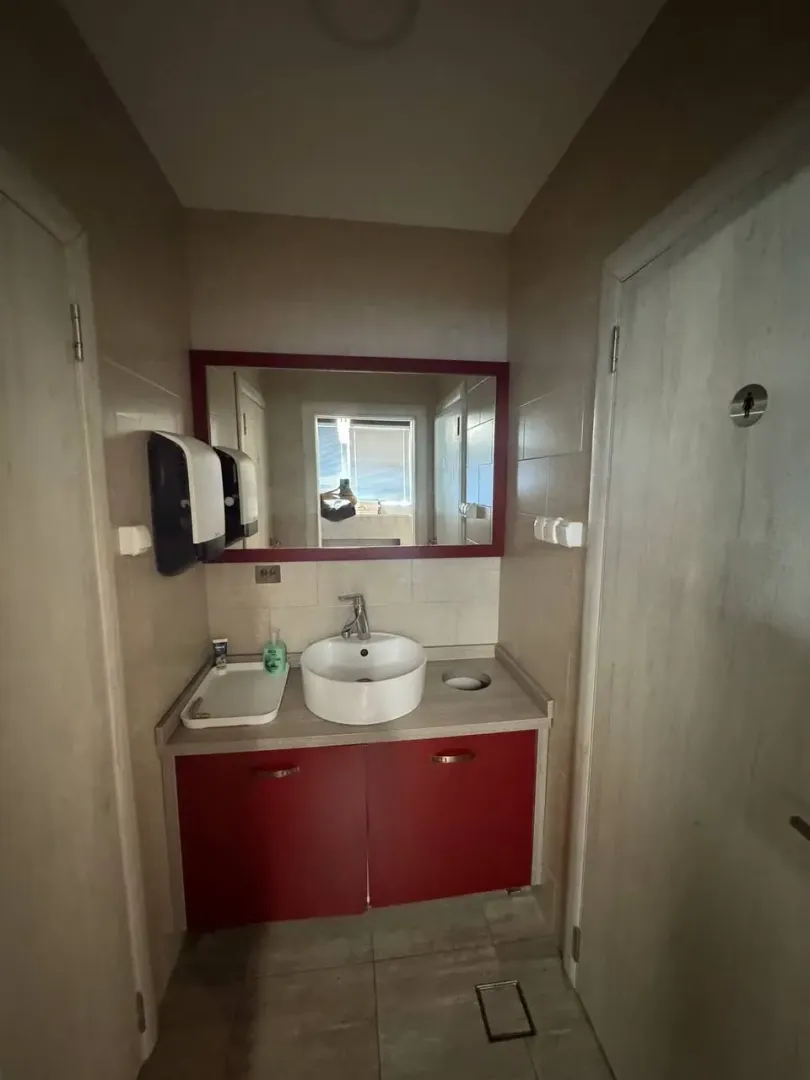 Small bathroom with a sink and a large mirror.