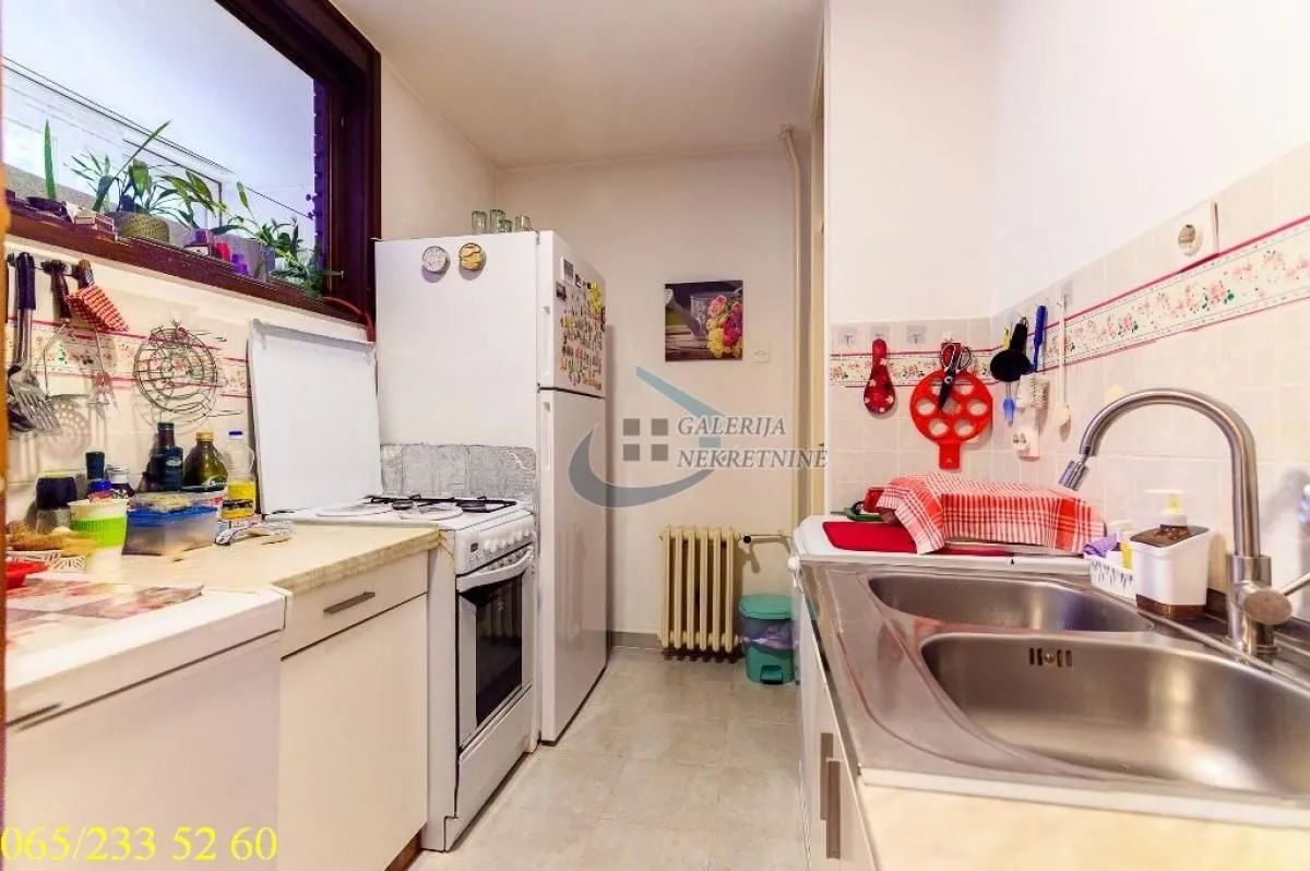 Small kitchen with a sink, stove, and refrigerator.
