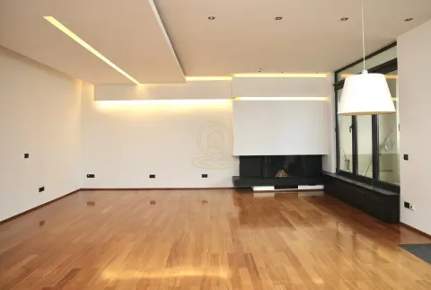 Spacious living room with wooden flooring, modern ceiling lighting, and a built-in fireplace. - image 4