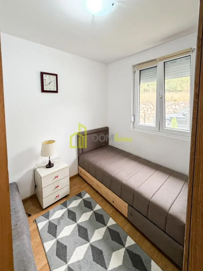 Smaller bedroom with a pull-out bed and a nightstand.