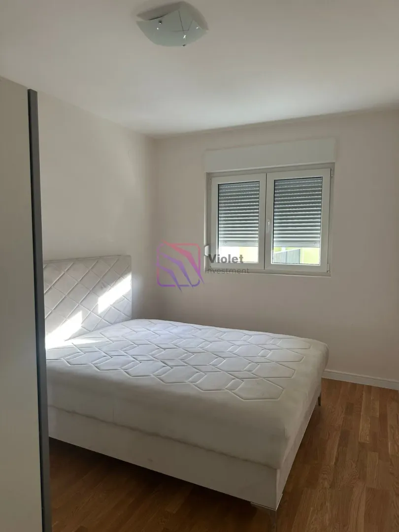 Bedroom with a double bed and a window.