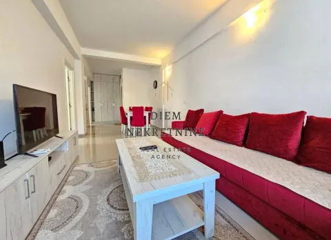 Living room with a sofa and TV. - image 2