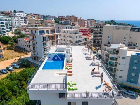 Bird's-eye view of a building terrace with a swimming pool and sun loungers. - image 20