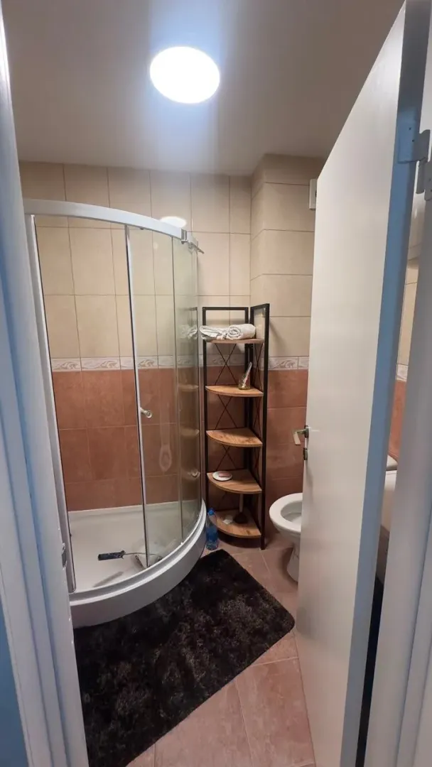 Smaller bathroom with a shower cabin and ceramic tiles.