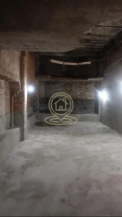 Empty room in a rough construction phase with exposed walls.