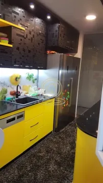 Modern kitchen with yellow elements and a built-in refrigerator. - image 7