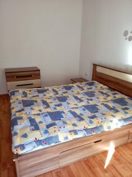 Bedroom with a double bed and a wooden dresser. - image 7