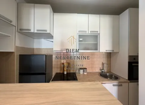 Small equipped kitchen with white cabinets and a refrigerator. - image 5