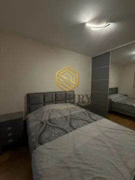 Bedroom with a double bed, bedside tables, and a large built-in wardrobe with a mirror. - image 5