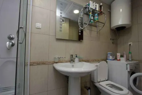 Bathroom with sink and washing machine. - image 14