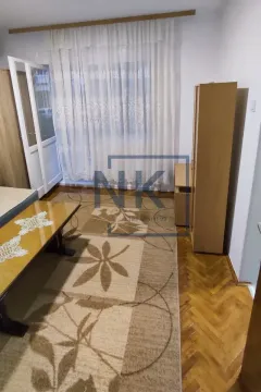Living room with parquet flooring, rug and wooden furniture. - image 2