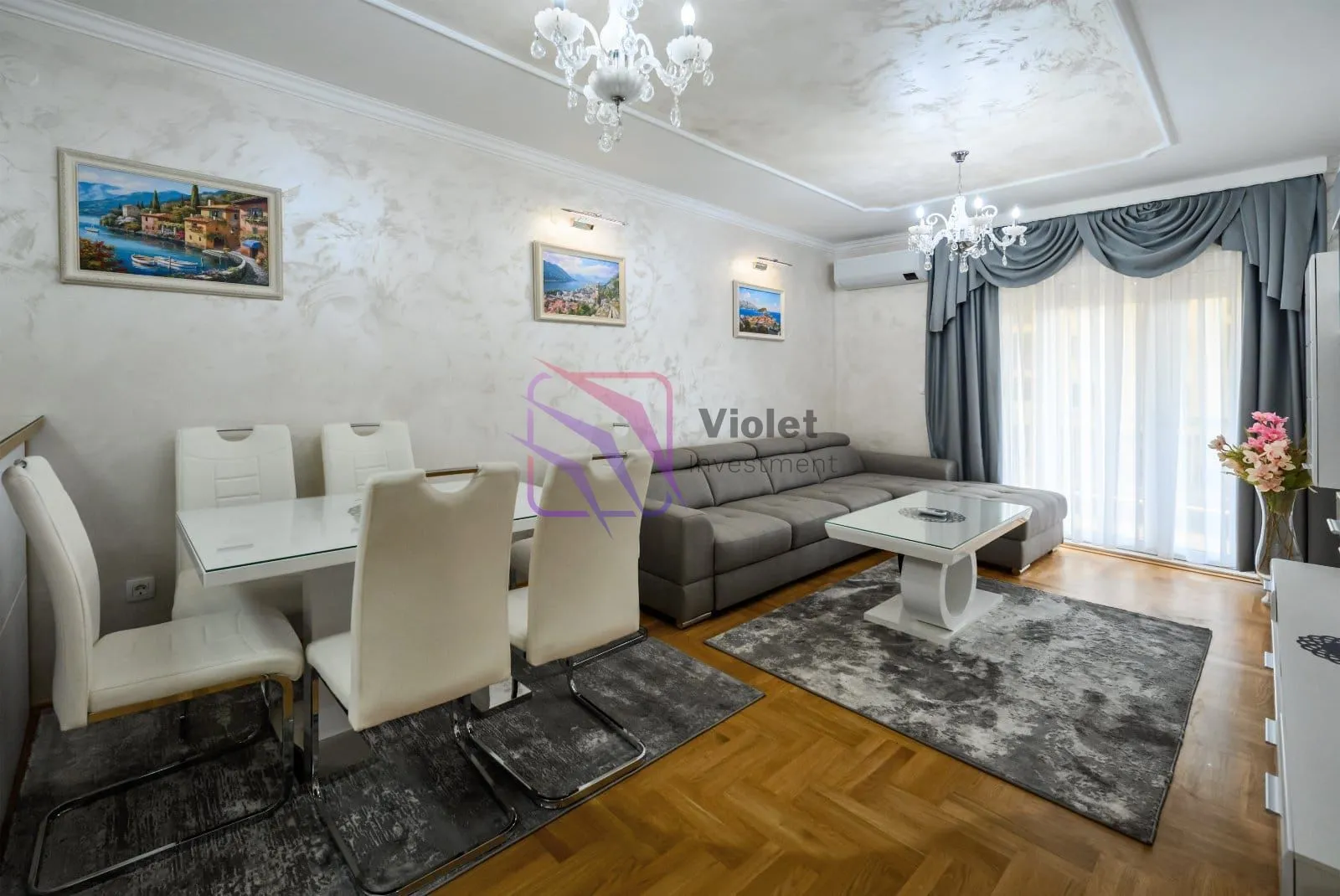 Living room with a sofa set, dining table, and chairs.