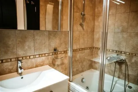 Bathroom with a shower and sink. - image 23