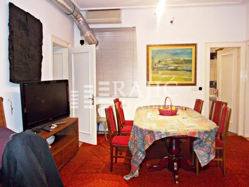 Living room with dining area and television.