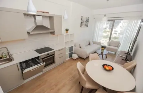 Living room with dining area and kitchen in light tones. - image 7