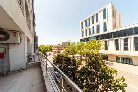 View from the balcony overlooking the city street and surrounding buildings. - image 10