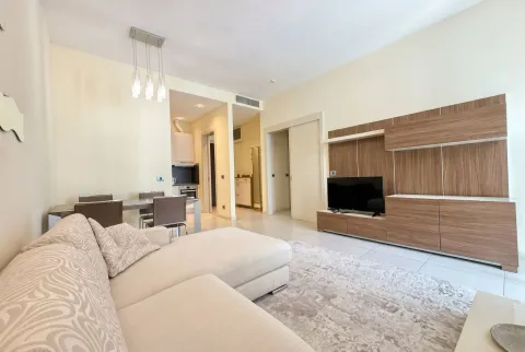 Spacious and bright living room with a sofa and TV unit. - image 4