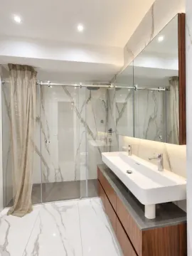 Modernly equipped bathroom with a washbasin and a walk-in shower. - image 14