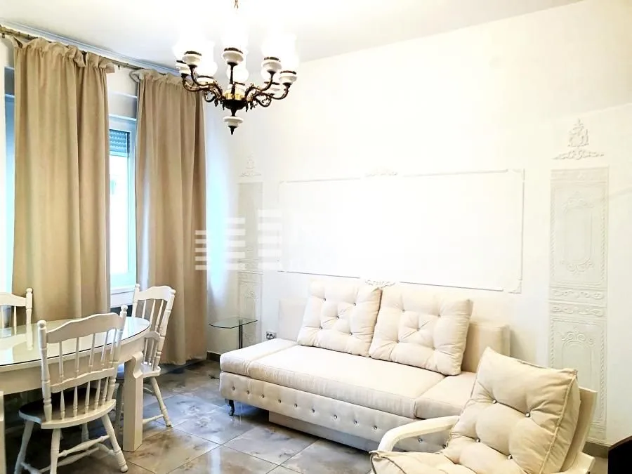 Living room with a sofa set and dining table.