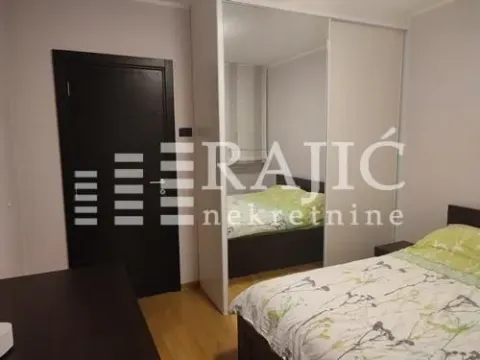 Furnished bedroom with a large wardrobe and a double bed. - image 7