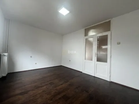 Empty room with dark parquet flooring and white doors. - image 7