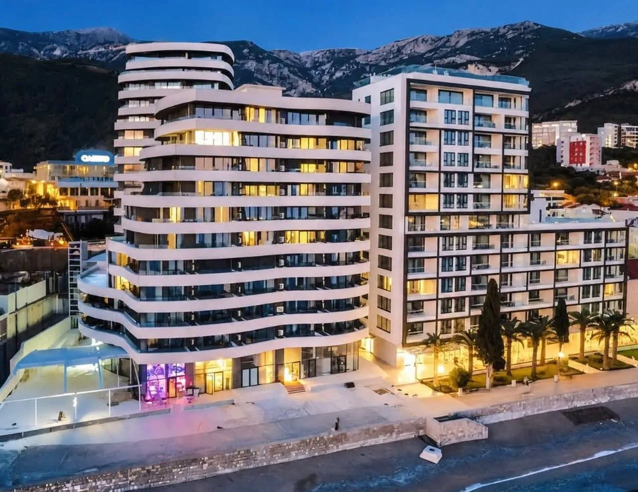Aerial view of a modern residential complex with balconies in the evening.