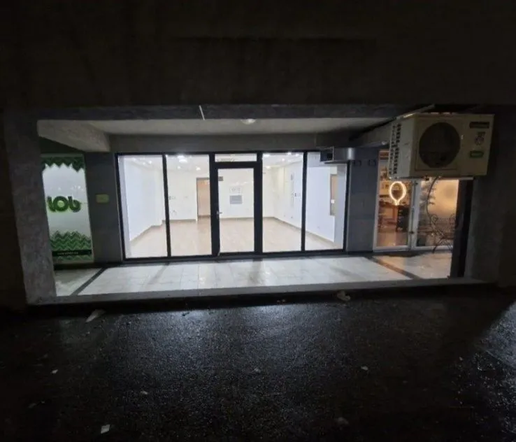 Exterior view of a commercial space with a glass storefront.