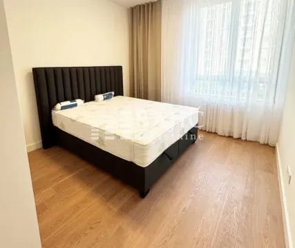 Bedroom with a double bed and wooden flooring. - image 14