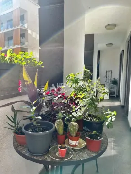 Balcony with a table and potted plants. - image 3