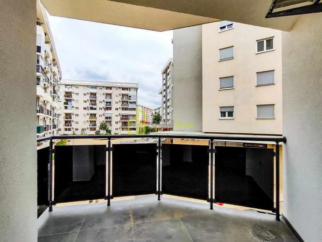 View from the balcony overlooking surrounding residential buildings and the neighborhood.