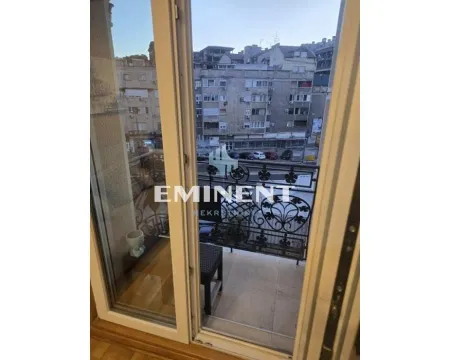 View from the balcony onto the city street and surrounding buildings. - image 10
