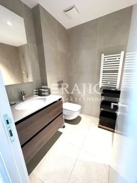 Modern bathroom with a washbasin, toilet, and ceramic tiles. - image 14