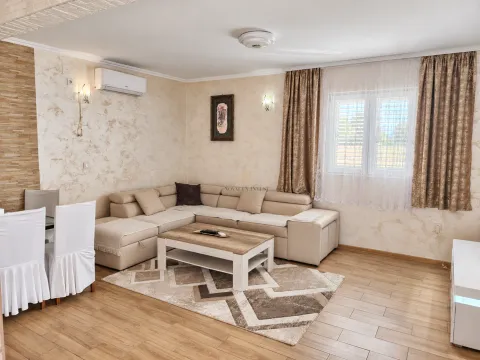 Spacious living room with a sectional sofa, dining table, and window. - image 5