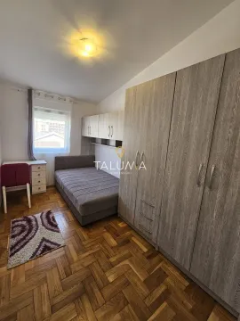 Furnished bedroom with a bed, large wardrobe, and a desk. - image 8