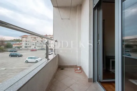 Covered balcony with metal railing and parking view. - image 3