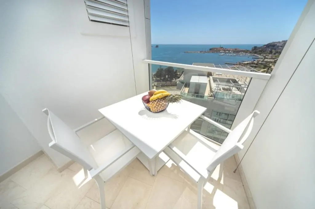 Balcony with a dining table and sea view.